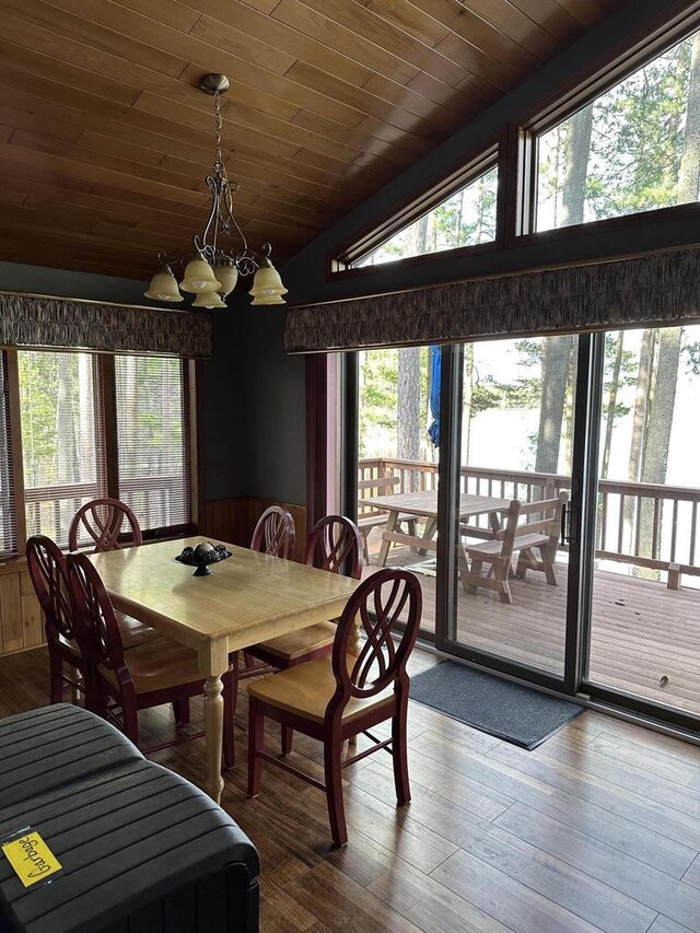 N11894 E Deer Lake Rd, Tomahawk, WI 54487 - dining room featuring vaulted ceiling, a chandelier, wood ceiling, healthy amount of natural light, and hardwood / wood-style floors
