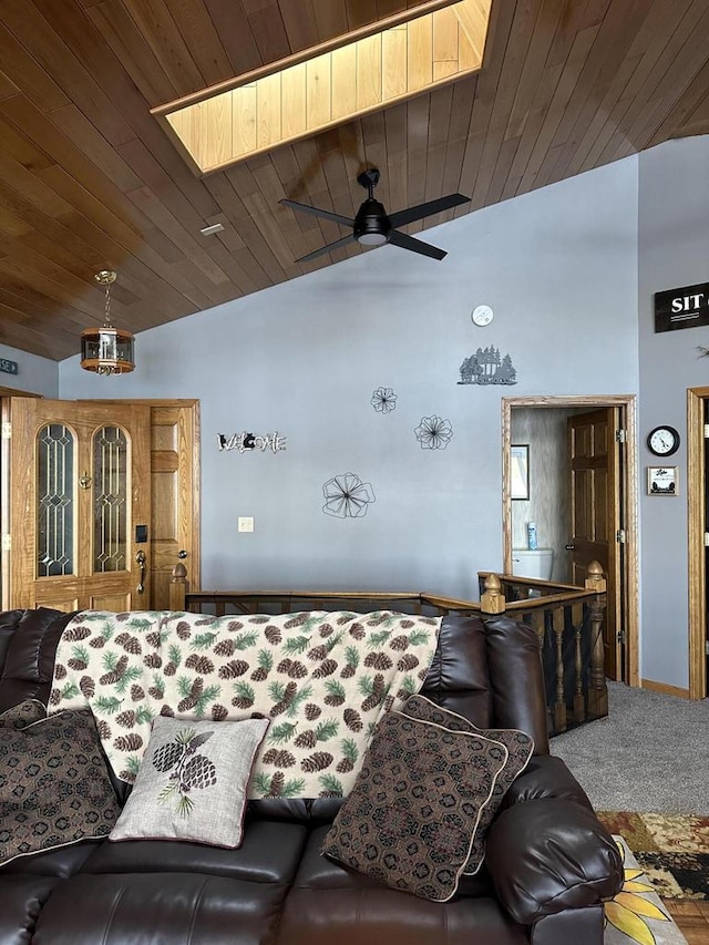 N11894 E Deer Lake Rd, Tomahawk, WI 54487 - carpeted living room with vaulted ceiling, a ceiling fan, wooden ceiling, and a skylight