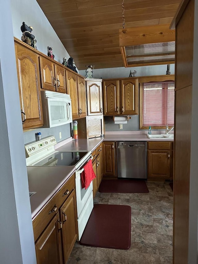N11894 E Deer Lake Rd, Tomahawk, WI 54487 - kitchen featuring white appliances, wood ceiling, a sink, stone finish floors, and brown cabinetry
