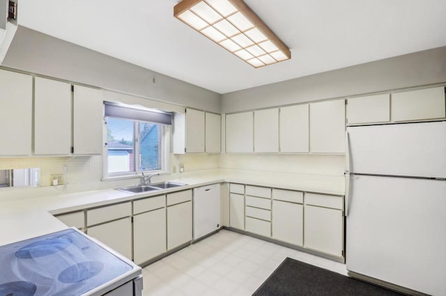 7700 3rd Ave, Kenosha, WI 53143 - kitchen featuring white appliances, a sink, light flooring, light countertops, and white cabinetry