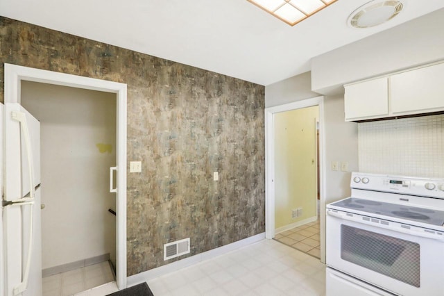 7700 3rd Ave, Kenosha, WI 53143 - kitchen featuring white appliances, white cabinets, and baseboards