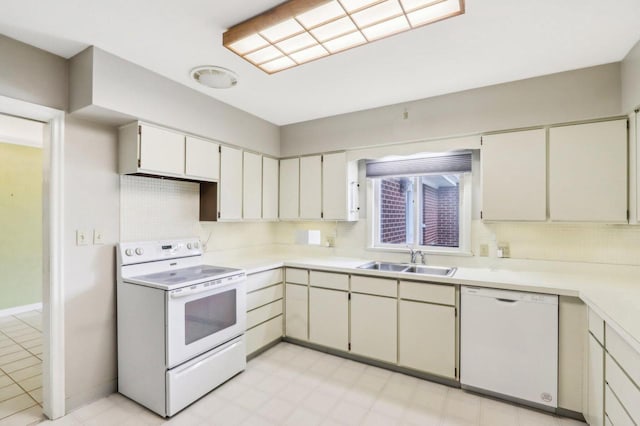 7700 3rd Ave, Kenosha, WI 53143 - kitchen with white appliances, a sink, backsplash, and light countertops