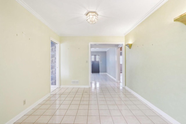7700 3rd Ave, Kenosha, WI 53143 - spare room with crown molding, light tile patterned flooring, and baseboards