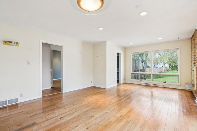 7700 3rd Ave, Kenosha, WI 53143 - unfurnished room with light wood-style floors, baseboards, recessed lighting, ornamental molding, and a baseboard heating unit