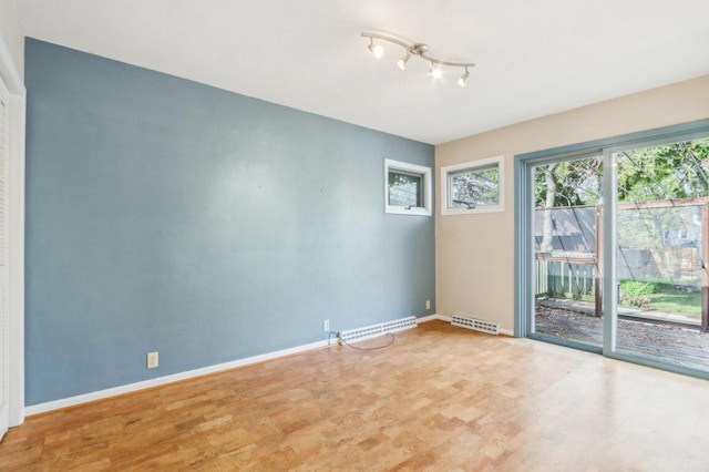 7700 3rd Ave, Kenosha, WI 53143 - empty room featuring wood finished floors and baseboards