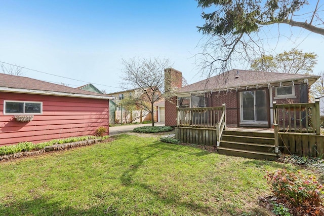 7700 3rd Ave, Kenosha, WI 53143 - rear view of house featuring a lawn, a wooden deck, a chimney, brick siding, and roof with shingles