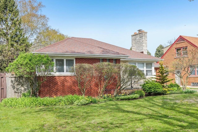 7700 3rd Ave, Kenosha, WI 53143 - view of property exterior featuring a chimney, brick siding, and a shingled roof