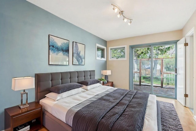 7700 3rd Ave, Kenosha, WI 53143 - bedroom featuring access to exterior, light wood-style flooring, and track lighting