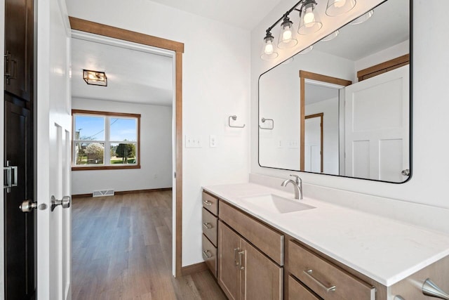4551 Menasha Ave, Manitowoc, WI 54220 - bathroom with baseboards, wood finished floors, and vanity