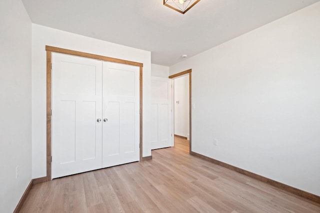 4551 Menasha Ave, Manitowoc, WI 54220 - unfurnished bedroom with light wood-style flooring, baseboards, and a closet