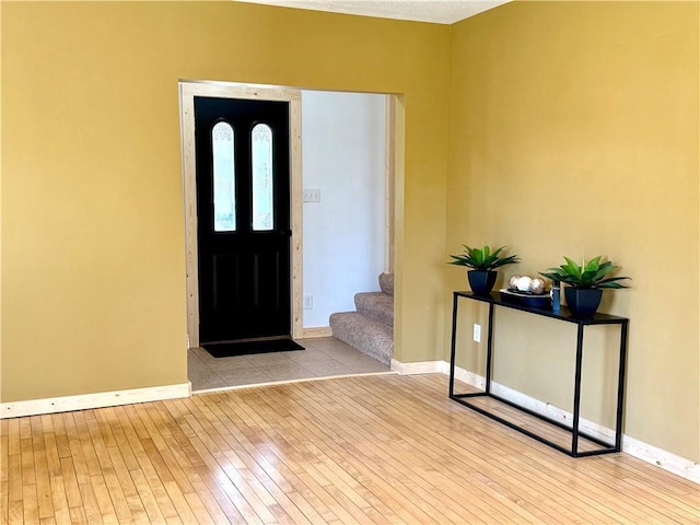 208 N 7th St, Cameron, WI 54822 - entrance foyer with wood-type flooring, baseboards, and stairs