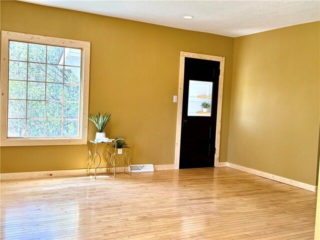 208 N 7th St, Cameron, WI 54822 - entrance foyer with hardwood / wood-style flooring, baseboards, and a textured ceiling