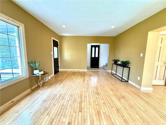 208 N 7th St, Cameron, WI 54822 - entryway featuring healthy amount of natural light, light wood finished floors, baseboards, recessed lighting, and a textured ceiling