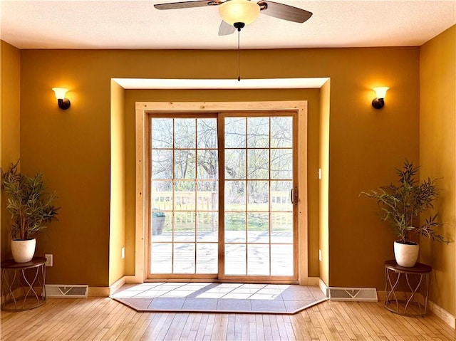 208 N 7th St, Cameron, WI 54822 - doorway featuring hardwood / wood-style flooring, a ceiling fan, and baseboards