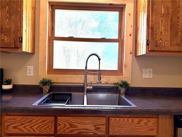 208 N 7th St, Cameron, WI 54822 - kitchen with a sink, dark countertops, and brown cabinets