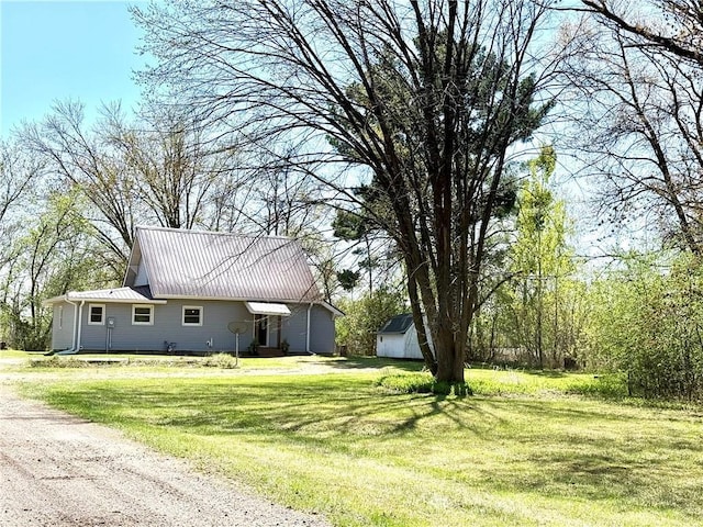 208 N 7th St, Cameron, WI 54822 - view of front of house featuring a front yard, metal roof, and an outbuilding