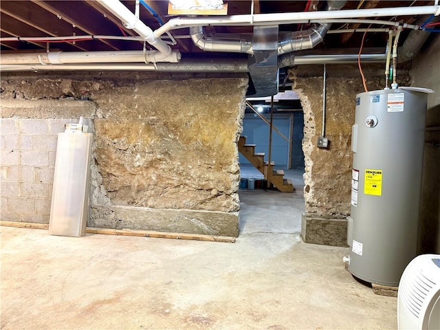 208 N 7th St, Cameron, WI 54822 - unfinished basement featuring electric water heater and stairway