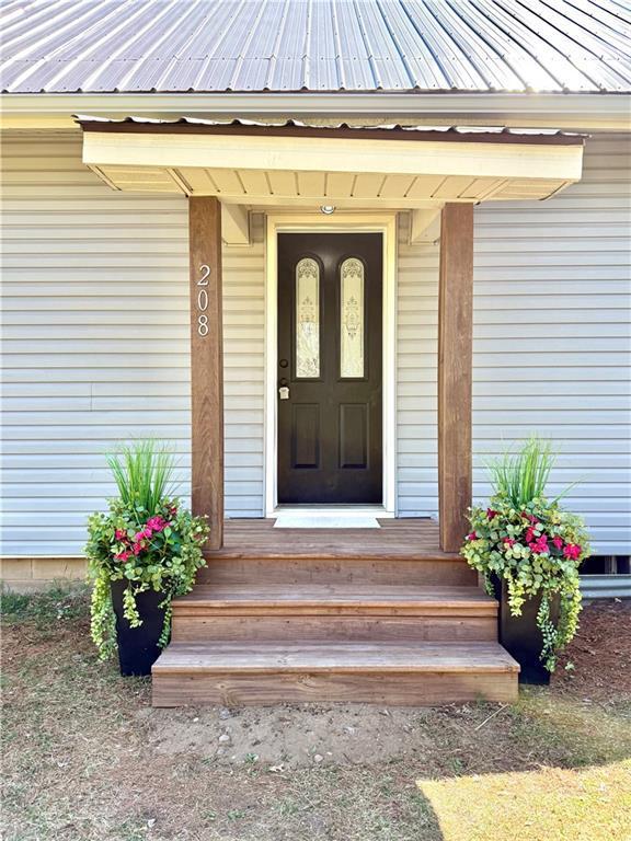 208 N 7th St, Cameron, WI 54822 - doorway to property featuring metal roof
