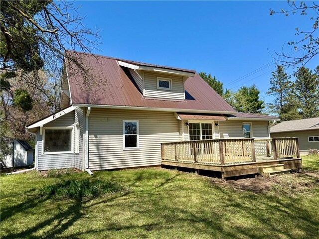 208 N 7th St, Cameron, WI 54822 - back of property with a yard, a wooden deck, metal roof, and an outdoor structure