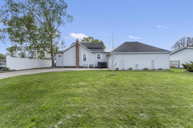 1301 Jackson St, Stoughton, WI 53589 - rear view of property with a chimney, a patio, and a shingled roof