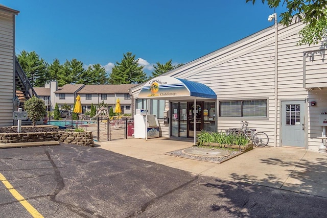 1093 Canyon Rd Unit 603, Wisconsin Dells, WI 53965 - view of building exterior with fence and a community pool