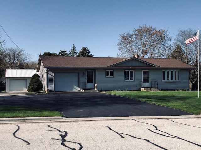 508 Roosevelt Ave, Howards Grove, WI 53083 - single story home featuring a garage, driveway, a front yard, and a chimney