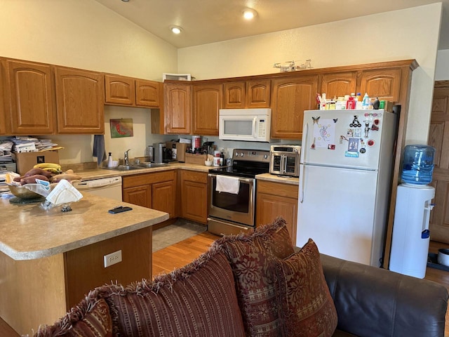 422 Callaway Blvd, La Crosse, WI 54603 - kitchen with white appliances, light countertops, a sink, a peninsula, and light wood-type flooring