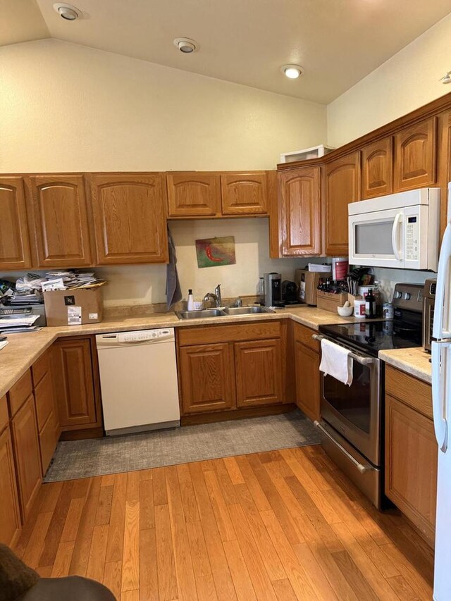 422 Callaway Blvd, La Crosse, WI 54603 - kitchen featuring white appliances, a sink, lofted ceiling, light countertops, and light wood-style floors