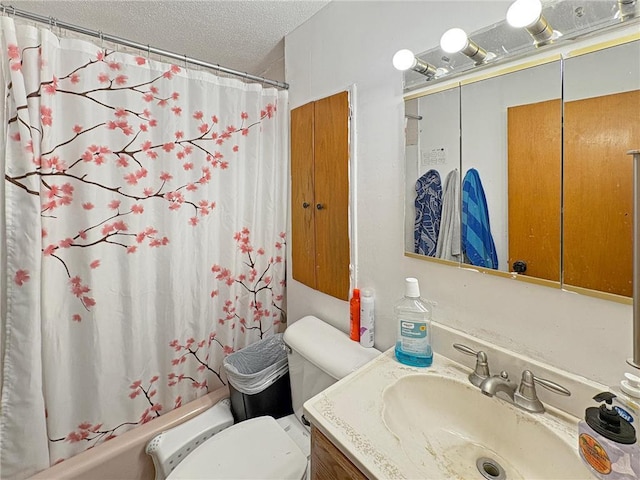 501 S 8th St, Luck, WI 54853 - bathroom featuring toilet, shower / bath combo with shower curtain, vanity, and a textured ceiling