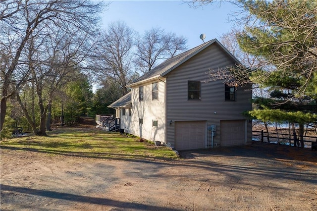 29825 Minerva Cir, Danbury, WI 54830 - view of side of property featuring an attached garage, dirt driveway, and fence