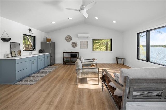 29829 Minerva Cir, Danbury, WI 54830 - living room with a wall mounted air conditioner, lofted ceiling, light wood finished floors, a ceiling fan, and recessed lighting