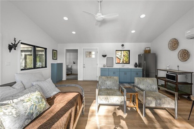 29829 Minerva Cir, Danbury, WI 54830 - bedroom with freestanding refrigerator, lofted ceiling, light wood finished floors, multiple windows, and recessed lighting