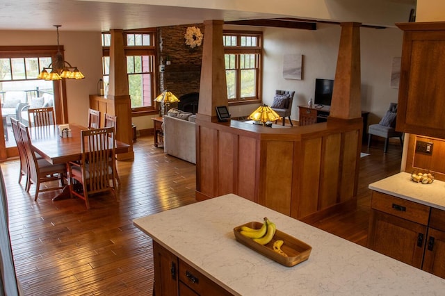 953 Larkspur Rd, Plymouth, WI 53073 - kitchen with open floor plan, brown cabinetry, dark wood finished floors, and a fireplace