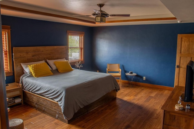 953 Larkspur Rd, Plymouth, WI 53073 - bedroom featuring a raised ceiling, wood-type flooring, baseboards, and a ceiling fan