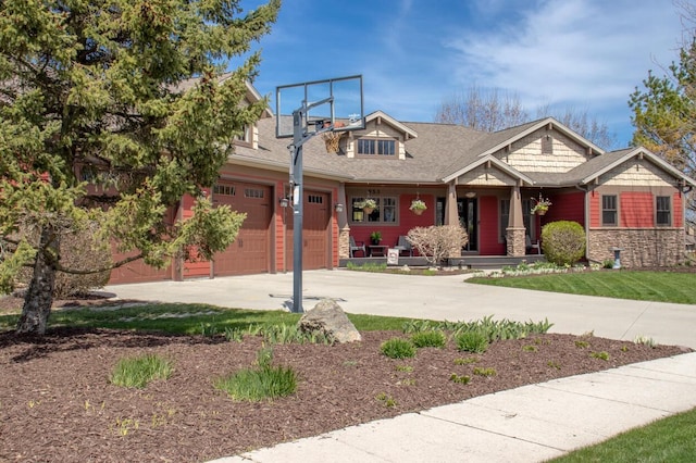 953 Larkspur Rd, Plymouth, WI 53073 - craftsman-style house with concrete driveway, covered porch, and stone siding