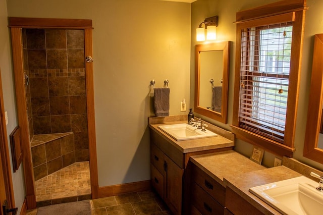 953 Larkspur Rd, Plymouth, WI 53073 - bathroom featuring a walk in shower, baseboards, and two vanities
