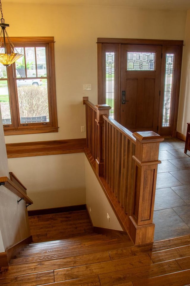 953 Larkspur Rd, Plymouth, WI 53073 - entryway featuring baseboards, dark wood-type flooring, and stairs