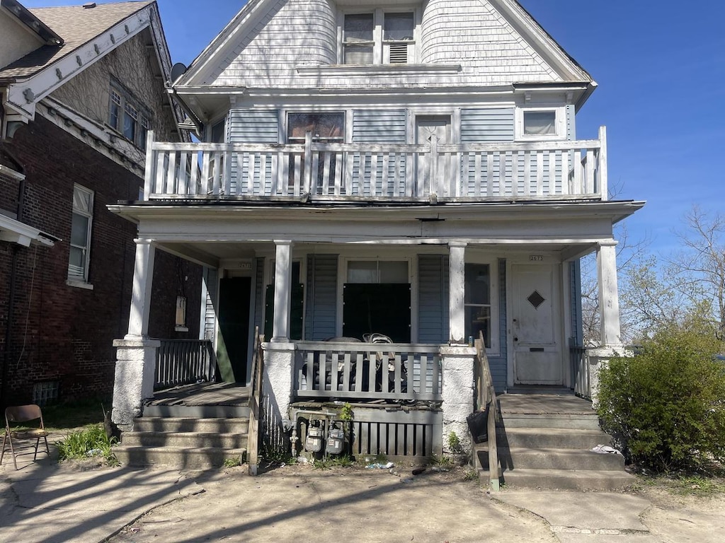 view of front of property with a balcony and a porch