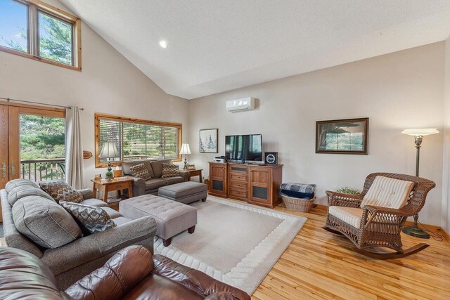 E9510 Oak Hill Rd, Wisconsin Dells, WI 53965 - living area with an AC wall unit, light wood finished floors, high vaulted ceiling, and recessed lighting