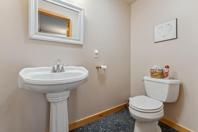 E9510 Oak Hill Rd, Wisconsin Dells, WI 53965 - half bathroom featuring baseboards, toilet, and a sink