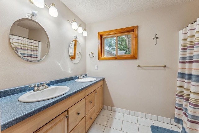 E9510 Oak Hill Rd, Wisconsin Dells, WI 53965 - full bath with tile patterned floors, double vanity, a textured ceiling, and baseboards