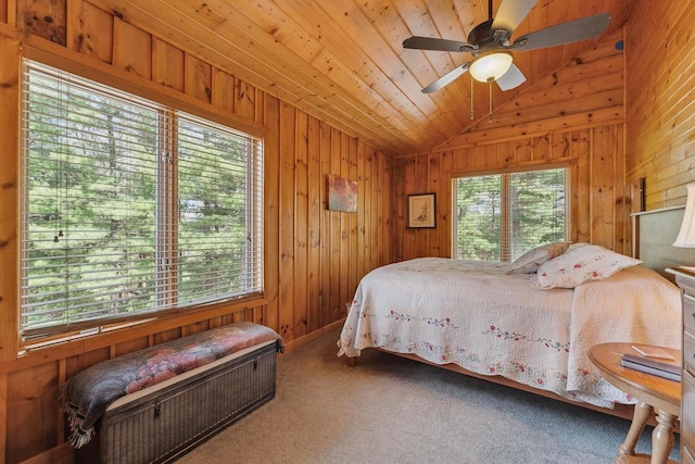 E9510 Oak Hill Rd, Wisconsin Dells, WI 53965 - carpeted bedroom featuring lofted ceiling, multiple windows, wooden walls, and ceiling fan
