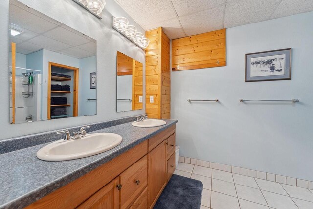E9510 Oak Hill Rd, Wisconsin Dells, WI 53965 - full bathroom featuring a paneled ceiling, tile patterned flooring, double vanity, a shower, and a spacious closet