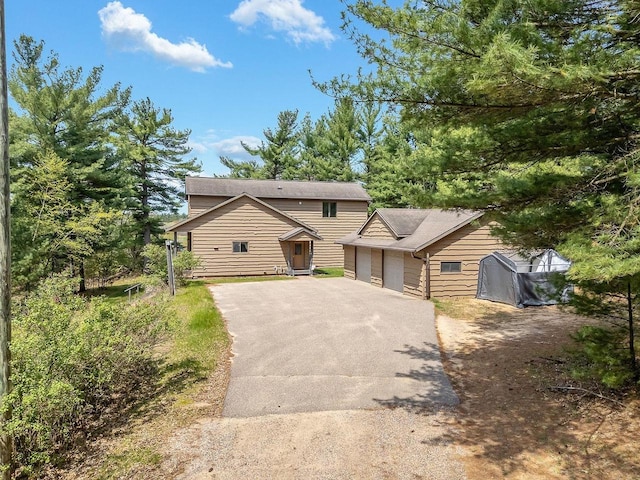 E9510 Oak Hill Rd, Wisconsin Dells, WI 53965 - view of front of home featuring asphalt driveway and a garage