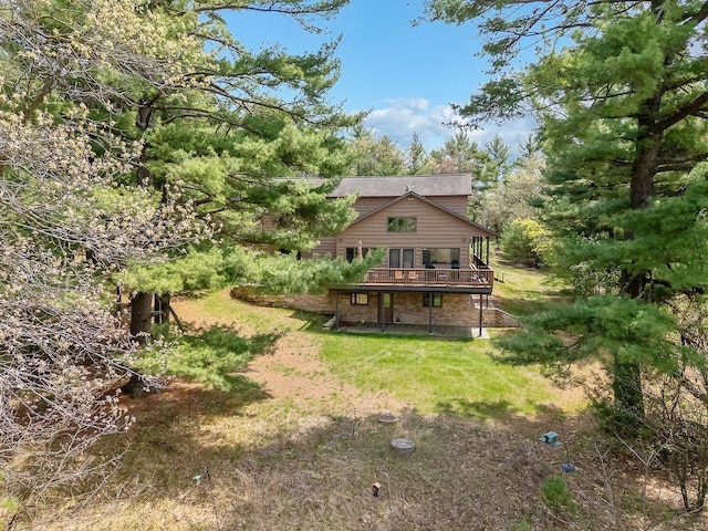 E9510 Oak Hill Rd, Wisconsin Dells, WI 53965 - rear view of house featuring a wooden deck and a lawn