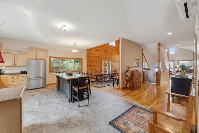 E9510 Oak Hill Rd, Wisconsin Dells, WI 53965 - kitchen with freestanding refrigerator, light brown cabinets, baseboards, a textured ceiling, and backsplash