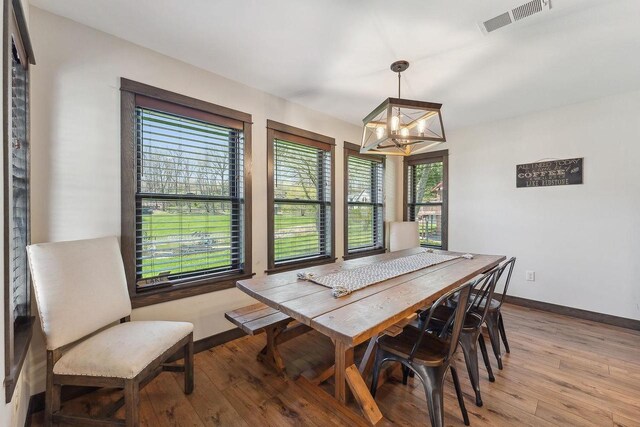 S952 W Redstone Dr, La Valle, WI 53941 - dining space featuring a chandelier, light wood-style flooring, and baseboards