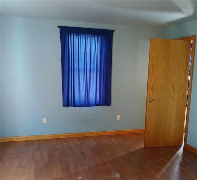 N34855 County Rd S, Blair, WI 54616 - unfurnished room with baseboards and wood finished floors