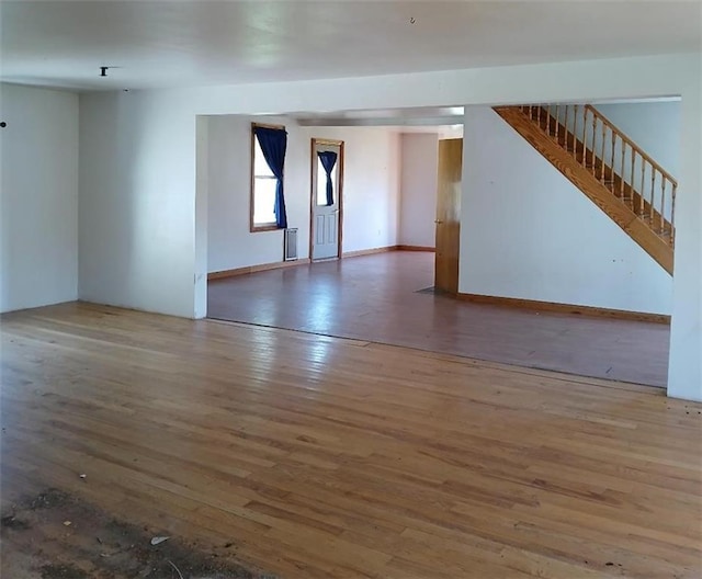 N34855 County Rd S, Blair, WI 54616 - unfurnished living room featuring wood finished floors and stairway