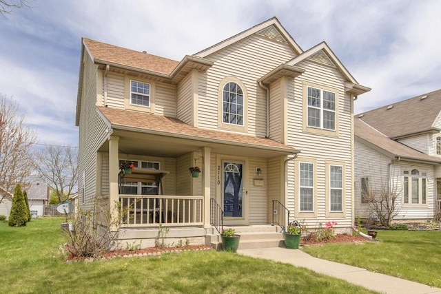 traditional home with a porch, a front lawn, and a shingled roof